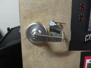 This photo was taken during one of our school hazard and vulnerability assessments.  A staff member locked their keys in the band room and cut this hole in the door to unlock the door.  This would not only make it easy for someone to steal expensive musical instruments, but makes an excellent safe room easy for an aggressor to enter.